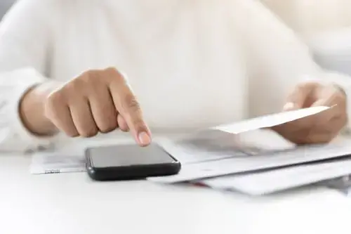 Woman using a calculator to check her tax code